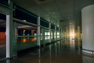 Empty modern international airport hall with sunset sunlight on background - 287442337