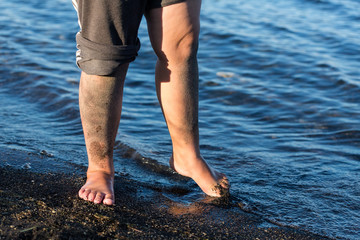 Child standing on the beach in the water