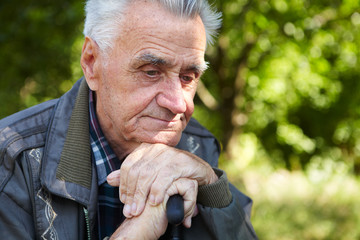 Elderly poor man thinks about life