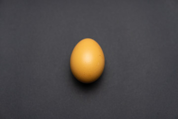 An egg is standing on a black table. Easter egg background. Very beautiful egg.