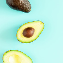 Avocado minimal pattern. Border made of green avocado on light blue background. Flat lay, top view, copy space, square