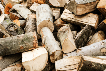 Concept image of preparing firewood for the winter - pile of chopped firewood ( vintage intensity effect)