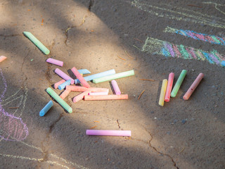 Children draw on the pavement with chalk.