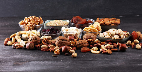 Composition with dried fruits and assorted healthy nuts on rustic background