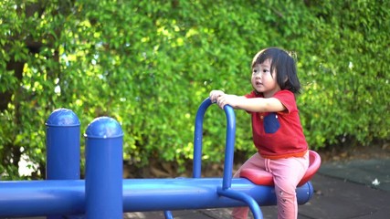 A cute young Asian Child baby girl kid age 2 plays in playground ,Concept photo childhood 