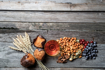 Top view of tea with nuts, berries, muffin, and fall nuts.