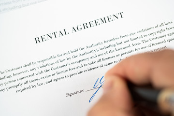 signing a rental agreement close up