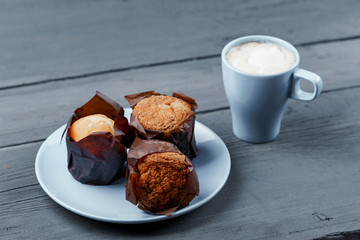 Capucino with muffin on table