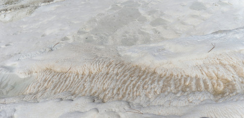 Snow-white salt deposits on the stone slopes created natural patterns.