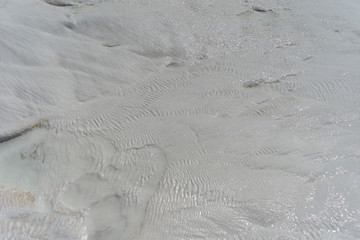 Snow-white salt deposits on the stone slopes created natural patterns.