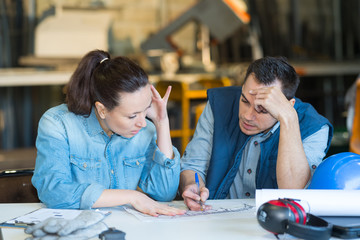 industrial worker and client studying a possible design