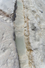 Snow-white salt deposits on the stone slopes created natural patterns.