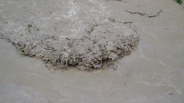 Involued muddy waters after heavy rain.Torrent of muddy waters after the rain.