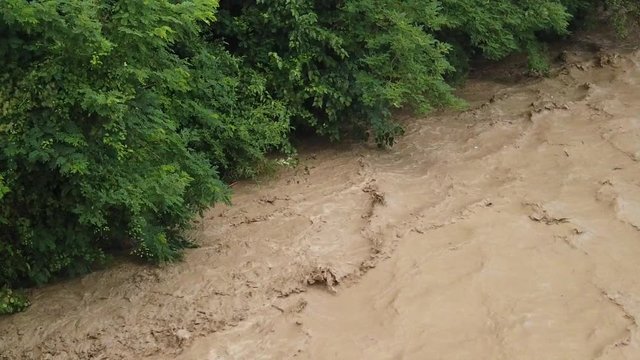 Involued muddy waters after heavy rain.Torrent of muddy waters after the rain.