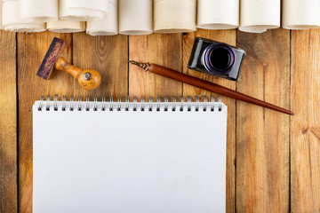 Old style calligraphy nib, ink and blank card on a wooden table. Writing accessories prepared for work.