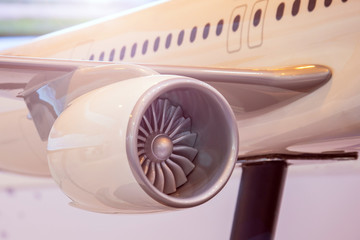 Engine on the wing of the aircraft with a warm backlight.