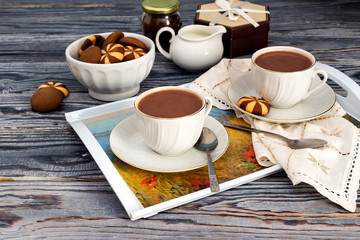 Cups with cocoa on a wooden table