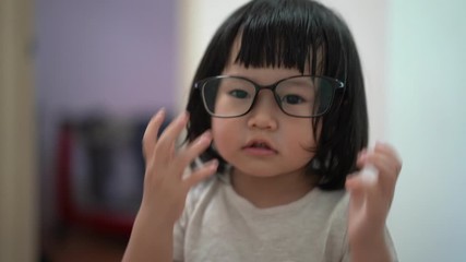 education, vision and childhood concept - Asian kid smiling student girl in glasses