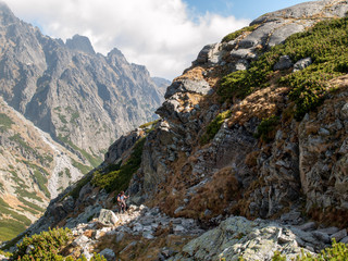  Hikers on trail at Great Cold Valley, Vysoke Tatry (High Tatras), Slovakia. The Great Cold Valley is 7 km long valley, very attractive for tourists