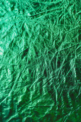The texture of the crinkled fabric in green neon color. Place for your text.