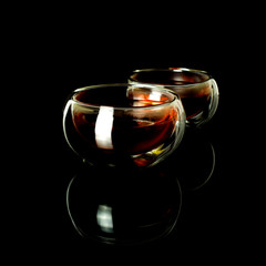 Chinese tea ceremony. Black tea in a glass jug and cups with a scoop of puerh tea on a tea desk.