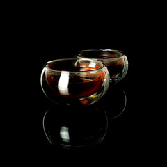 Chinese tea ceremony. Black tea in a glass jug and cups with a scoop of puerh tea on a tea desk.