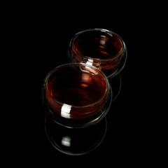 Chinese tea ceremony. Black tea in a glass jug and cups with a scoop of puerh tea on a tea desk.
