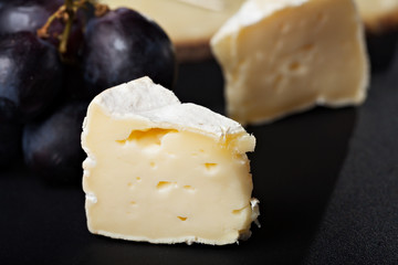 Fototapeta na wymiar closeup of swiss cheese with grapes and wine