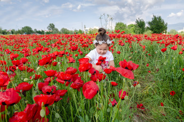 Beautiful kid  in poppy field.