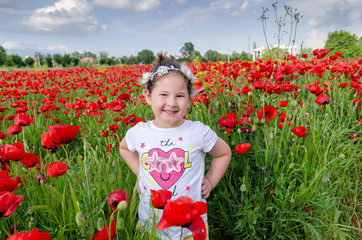 Beautiful kid  in poppy field.