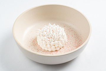 meringue with mango sauce on the white plate