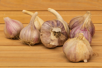 Some garlic on a wooden background close up