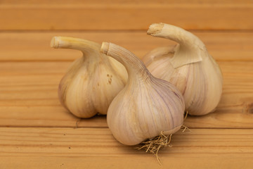 Some garlic on a wooden background close up