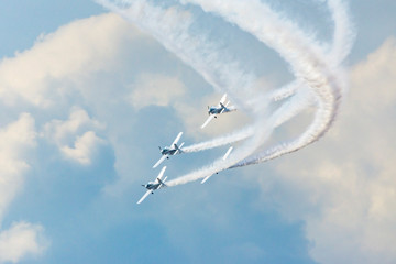 Airplanes on airshow. Aerobatic team performs flight at air show