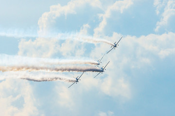 Airplanes on airshow. Aerobatic team performs flight at air show
