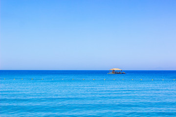 beautiful summer vacation destination Bungalow wooden house floating on a Red sea water surface in Gulf of Aqaba with horizon empty sky background with space for copy or text