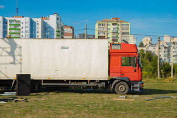 cargo truck in city in during unloading with city outskirts view background 