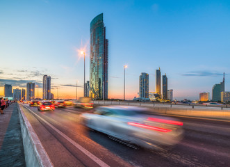 Fototapeta premium Skyscrapers and Traffic on Taksin Bridge in Bangkok, Thailand at Twilight