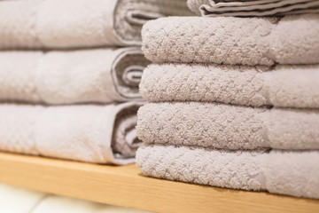 Shelves with towels stacks in shop. Hygge or another scandinavian style.
