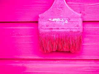old paint brush on wood background .