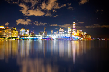 Fototapeta na wymiar New York City skyline towards lower Manhattan Financial District at night with lights