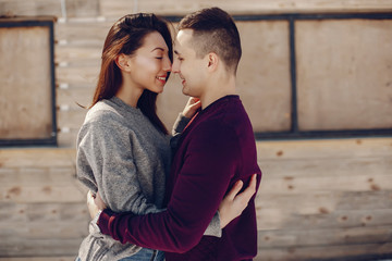 Cute couple have fun. Boy and girl in a winter park. Man in a red sweater. Brunette in a gray sweater