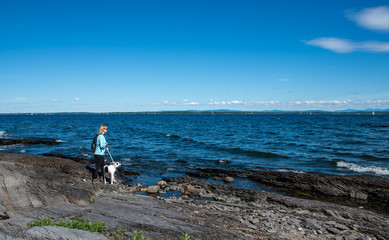 Fototapeta na wymiar woman with dog next to lake