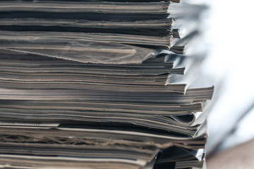 A stack of magazines, close-up macro filled the frame. A background for publishing or informational...