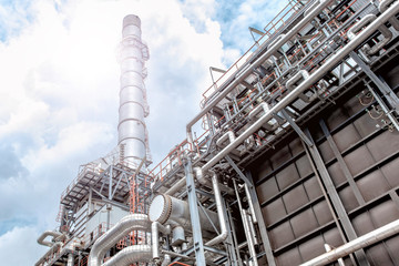 Oil and gas refinery plant form industry petroleum zone,Refinery equipment pipeline steel and oil storage tank at sunrise. -image