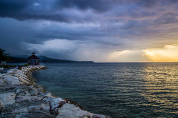 Rocky pathway towards gazebo by the shore