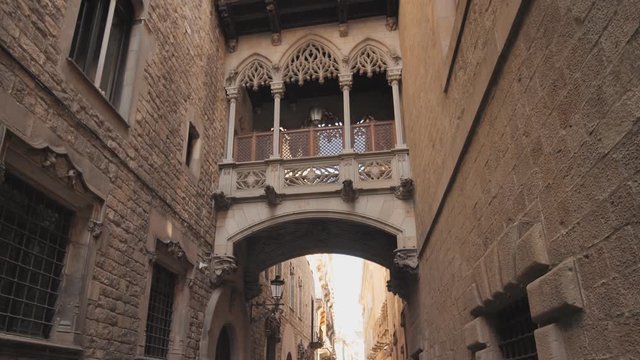 Bridge between buildings in Barri Gotic quarter of Barcelona, Spain. Old streets of Barrio Gotico in Barcelona, Catalonia. It is centre of old city of Barcelona. Center of touristic life.