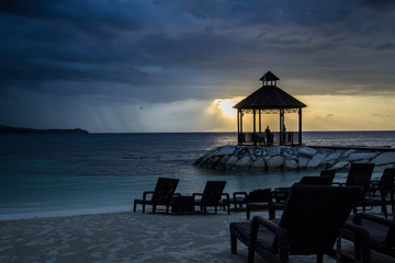 Gazebo by the beach with colorful sunset
