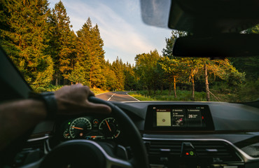 hands of car driver on steering wheel, road trip, driving on highway road