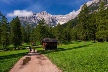 Two tourists are hiking in mountains, Val Fiscalina Dolomites.